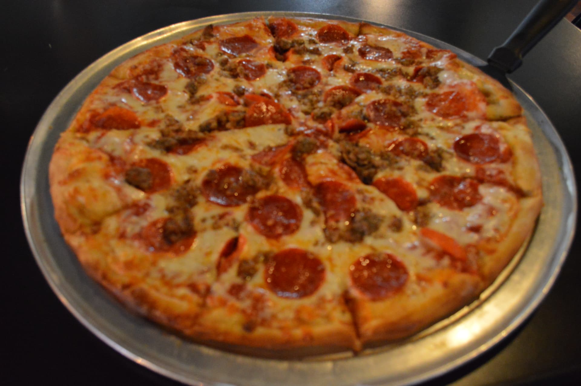 Hand-tossed pepperoni and sausage pizza fresh from the oven