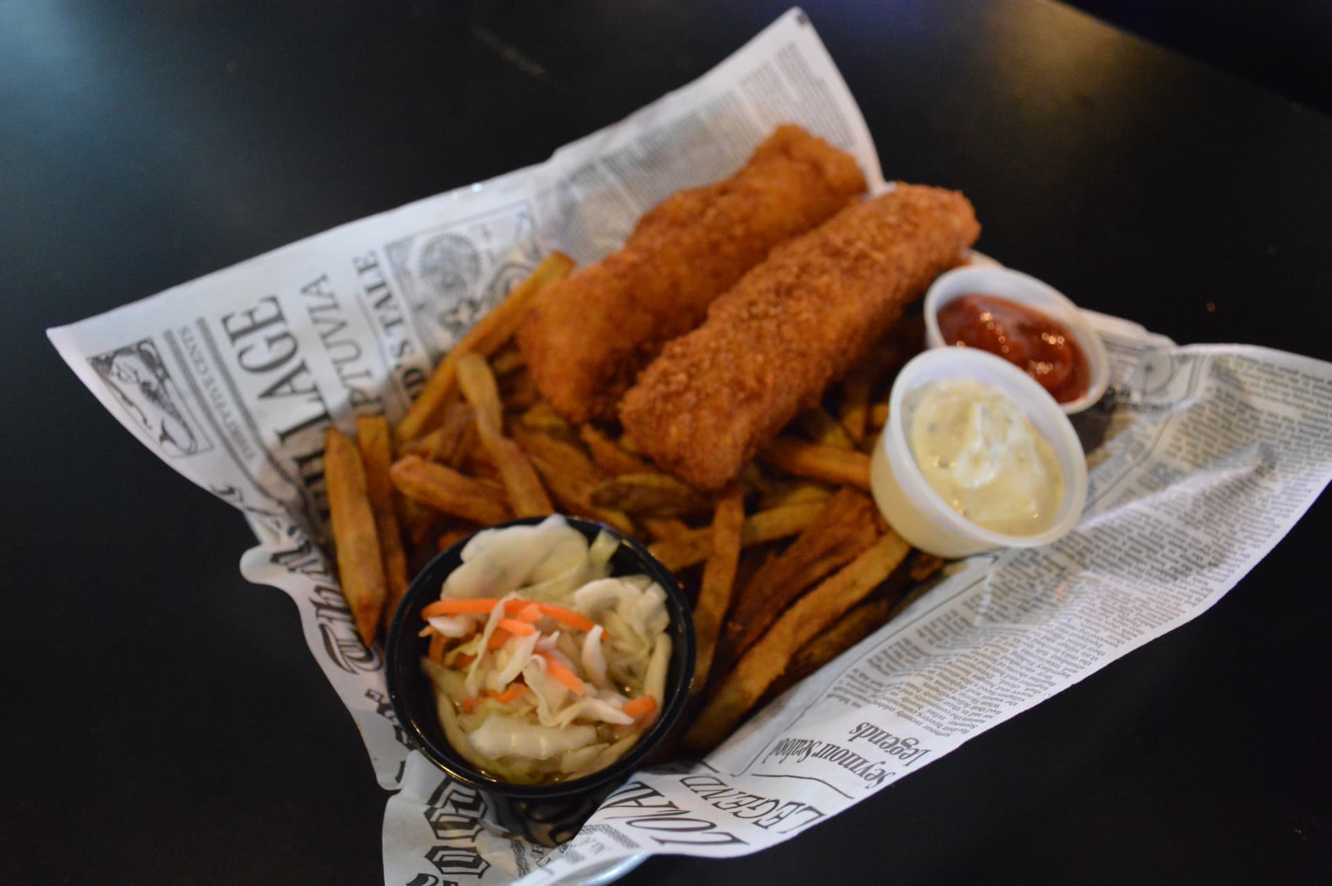 Fish and chips with fresh-cut fries, coleslaw, tartar sauce, and cocktail sauce